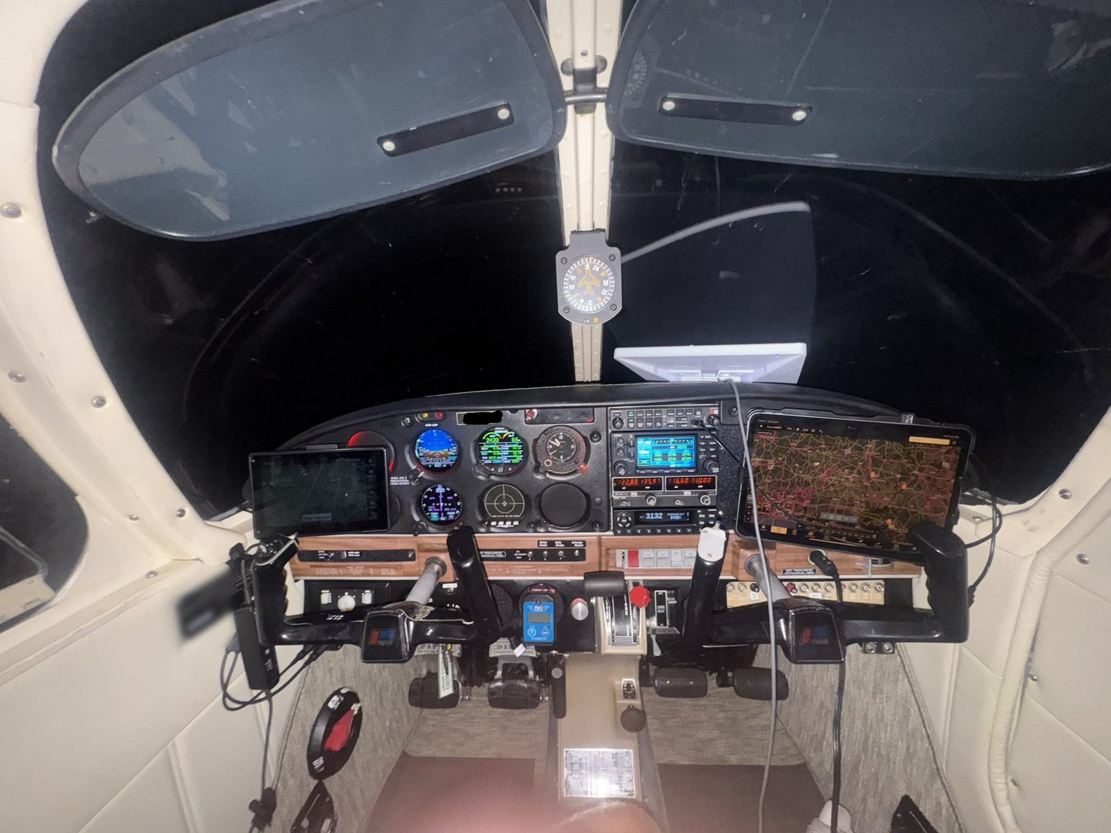The instrument panel lit up at night, showing the Garmin G5 attitude and HSI displays and the CGR-30P engine monitor